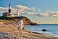 Woman tourist at the beach near Montauk Lighthouse, New York.