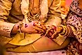 Indian wedding ceremony.hands of the bride held by a groom during a traditional ritual in an Indian Hindu Wedding