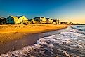 Waves in the Atlantic Ocean and morning light on beachfront homes at Edisto Beach, South Carolina.