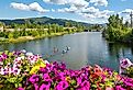 A group of kayakers enjoy a beautiful summer day on Sand Creek River and Lake Pend Oreille in the downtown area of Sandpoint, Idaho.