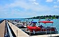 Pier and luxury boats docked in the Skaneateles Lake. Editorial credit: PQK / Shutterstock.com