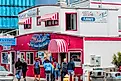 Dee Browning via Shutterstock. Newport, Oregon,USA: Tourist stand in front of Moe's seafood annex in downtown Newport.