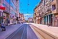 A scenic view of Main Street in Osijek, showcasing the city's vibrant urban landscape, historical buildings, and modern city life along the street. Image credit: ZdravkoT via Shutterstock.