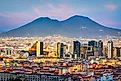 Naples, Italy with the financial district skyline under Mt. Vesuvius at twilight.