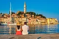 A couple relaxes by the water in the friendly town of Rovinj, Croatia, via Shutterstock user fokke barrssen.