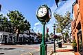 Downtown in nice day with clock, store fronts, restaurant and blue sky on Elm Street