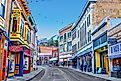 Buildings lining Main Street on a clear day at the edge of Bisbee, Arizona