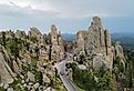 The Needles Highway in South Dakota, with winding road passing through towering, needle-like rock formations.