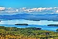 Aerial view of Lake Winnipesaukee, New Hampshire with mountains in the distance.