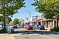 Cars on the street in downtown Astoria, Oregon with Astoria-Megler Bridge in the background