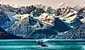 A whale breaches in an Alaskan bay.