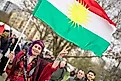 Kurdish woman with Kurdish flag. Via Shutterstock / Mahmoud Mahdi Photo