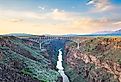 Taos, New Mexico, USA at Rio Grande Gorge Bridge over the Rio Grande at dusk. Image credit Sean Pavone via Shutterstock.