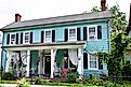 A beautifully restored colonial-style home, painted blue with black shutters, in the historical district of downtown Laurel, Delaware. Editorial credit: Dee Dalasio / Shutterstock.com