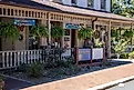 Dahlonega, Georgia: Hanging plants, wall decorations, and colorful signs create an inviting entrance to a business in the historic district, Editorial credit: Jen Wolf / Shutterstock.com