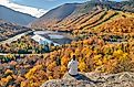 Woman hiking at Artist's Bluff near Echo Lake, Franconia Notch State Park in New Hampshire, USA during the fall.