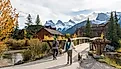 Residents walking the dogs in Town of Canmore in fall season. Image Credit Shawn.ccf via Shutterstock.