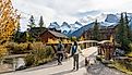 Residents walking the dogs in Town of Canmore in fall season. Image Credit Shawn.ccf via Shutterstock.