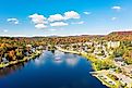 Colorful aerial view of Saranac Lake New York in the Adirondack Mountains during the fall.