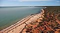 Monkey Mia, where the desert meets the sea and untouched vibrant red sand and blue ocean in Francois Peron National Park, Western Australia