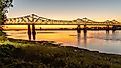Sunset on the Mississippi River in Natchez, Mississippi with the Natchez-Vidalia Bridge.