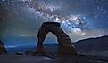 Delicate Arch in Arches National Park under a Milky Way galaxy.