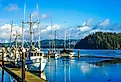 Old small fishing boat in harbor in Florence, Oregon. Image credit NeungPH via Shutterstock