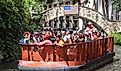 Boat full of tourists sightseeing the downtown from San Antonio River. Editorial credit: Moab Republic / Shutterstock.com