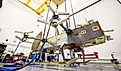 Dragonfly suspended by bungee cords during its ground vibration testing. By NASA/Johns Hopkins APL/Ed Whitman - https://science.nasa.gov/blogs/dragonfly/2026/07/09/nasas-dragonfly-clears-key-tests-as-titan-rotorcraft-takes-shape/, Public Domain, Wikimedia