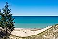 The fresh blue waters of Lake Michigan meet the beaches and wild-grass-strewn dunes along its southeastern shore.