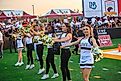 Army West Point Football faces off against the University of Louisiana at Monroe Warhawks at Malone Stadium in Monroe, Louisiana, with players on the field and fans filling the stands.