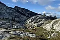 Camping near a rocky outcrop in the Pacific Northwest backpacking, summer hiking, colorful tents.