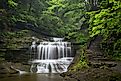 Waterfall cascades through Buttermilk Falls State Park, Ithaca, New York