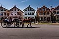 A horse-drawn carriage passes tourists by a row of ornate Victorian gingerbread houses in Cape May, New Jersey. Editorial credit: Steve Rosenbach / Shutterstock.com
