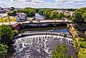 Valley Falls and Board Street bridge over Blackstone River at Valley Falls Heritage Park, Central Falls, Rhode Island.
