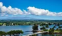 A view of Hilo, Hawaii and Mauna Kea on a clear day such that you can see the telescopes on the mountain peak.