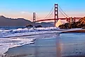 Famous Golden Gate Bridge view from Baker Beach at sunset in San Francisco, California. 
