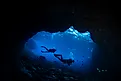 Two female scuba divers at the cave 'Buraco do Inferno' at the archipelago of Fernando de Noronha