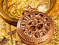 Vintage magnifying glass and pocket watch. Map of the Ancient World. Image credit RUl8let via shutterstock