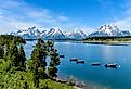 Spring view of a quiet bay of Jackson Lake, with Teton Range rising in the background, Grand Teton National Park, Wyoming.