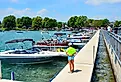 Pier and luxury boats docked in the Skaneateles Lake, New York. Image credit PQK via Shutterstock