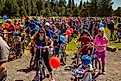 Children and adults just starting a ride in a 4th of july parade at Blask Butte Ranch resort near Sisters, Oregon. Editorial credit: Bob Pool / Shutterstock.com