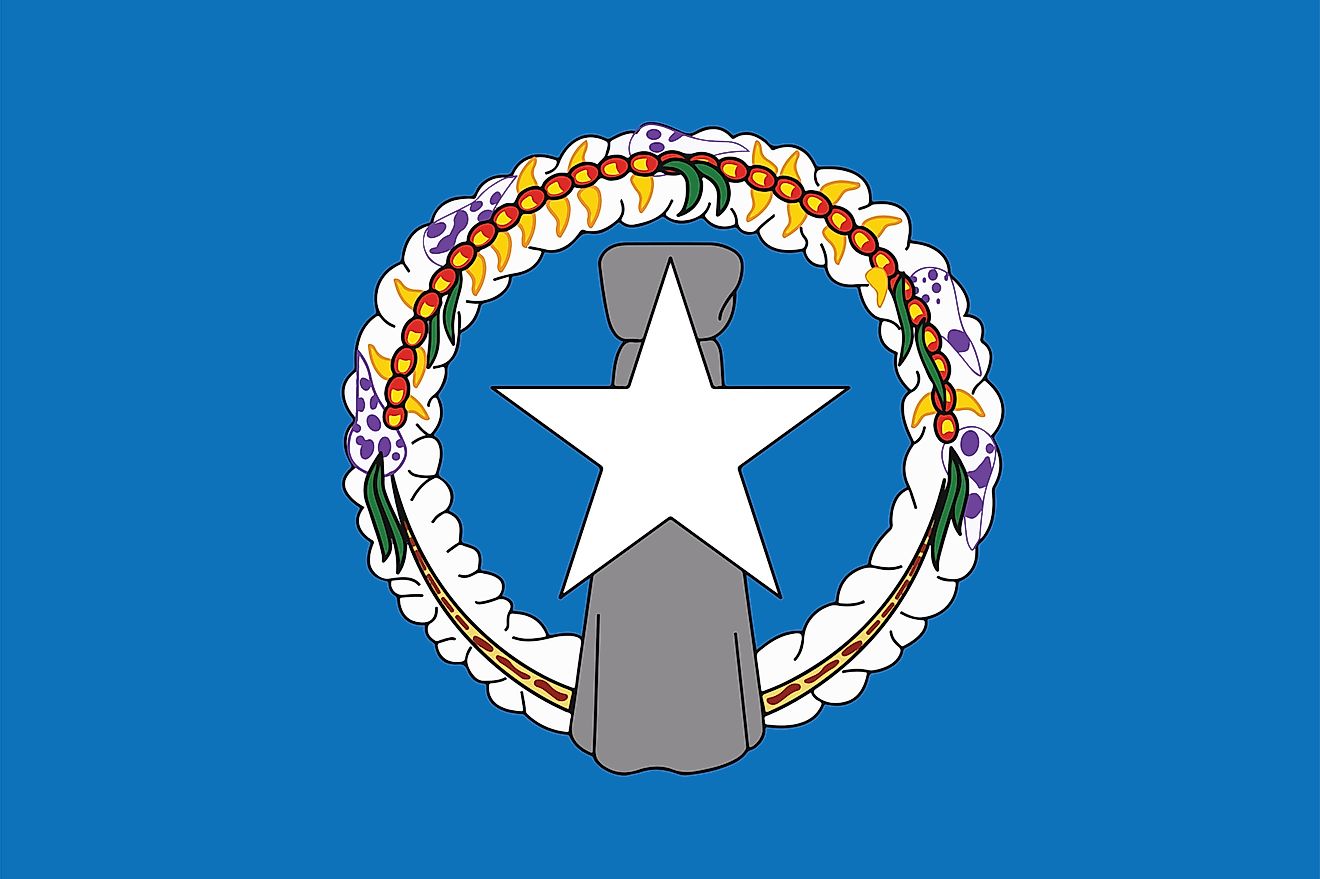 The Flag of the Commonwealth of Northern Mariana Islands features a blue background with a white, five-pointed star superimposed on a gray latte stone in the center. 