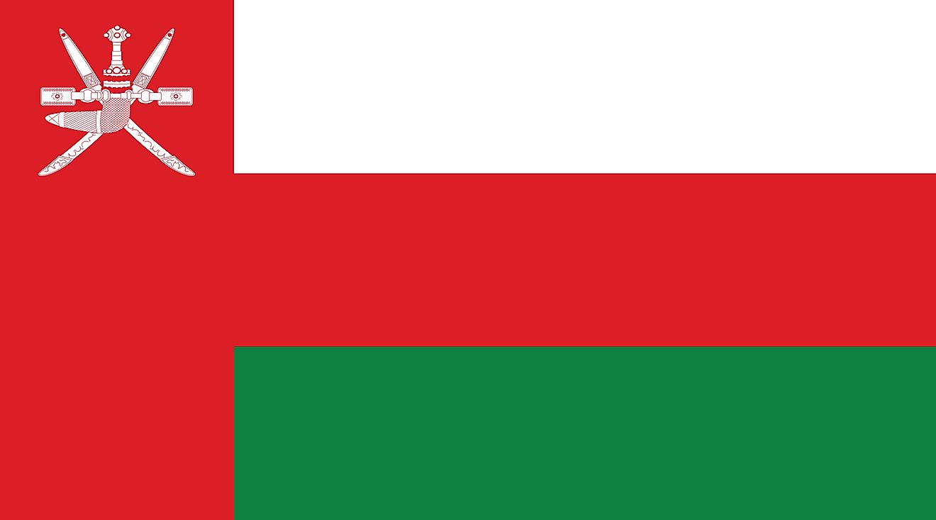 The flag of Oman is a tricolor of white (top), red, and green horizontal stripes, and a red vertical band on the hoist side, containing the national coat of arms at the top.
