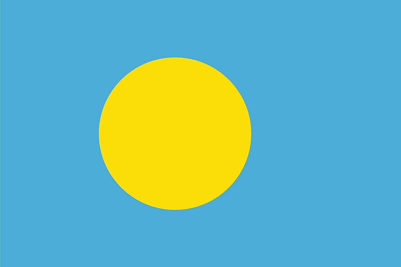 The national flag of Palau with a yellow disk representing the moon in a light blue background symbolizing the ocean.