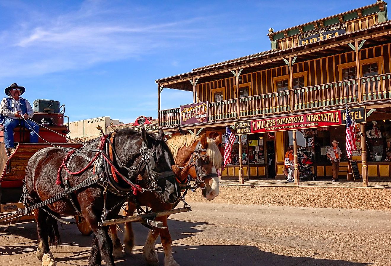 A stagecoach filled with tourists travels the historic streets of Tombstone, Arizona. Image credit CrackerClips Stock Media via Shutterstock