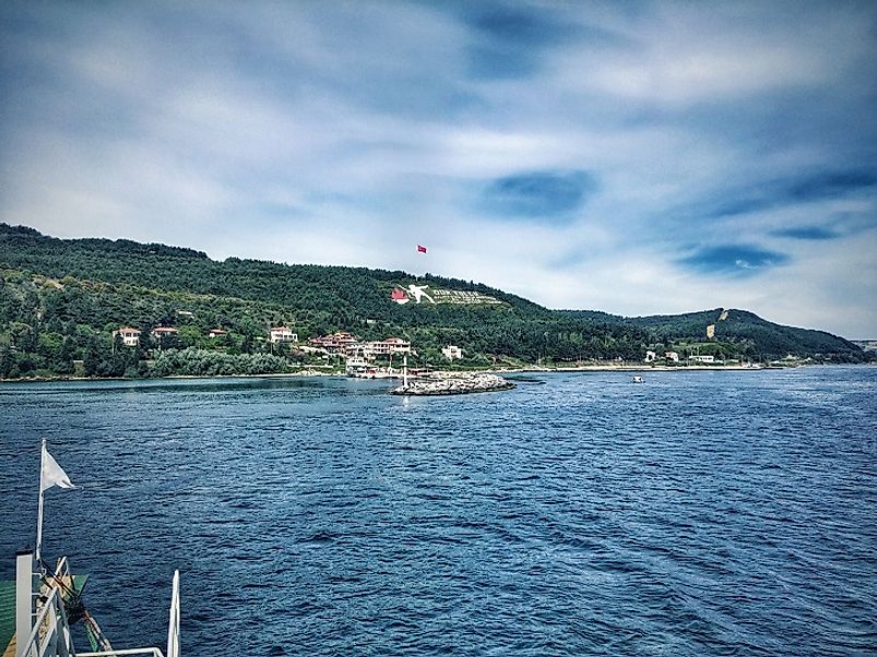 The Dur Yolcu monument to the fallen soldiers at Gallipoli in World War I (center of image) as seen from offshore upon the Dardanelles Strait.