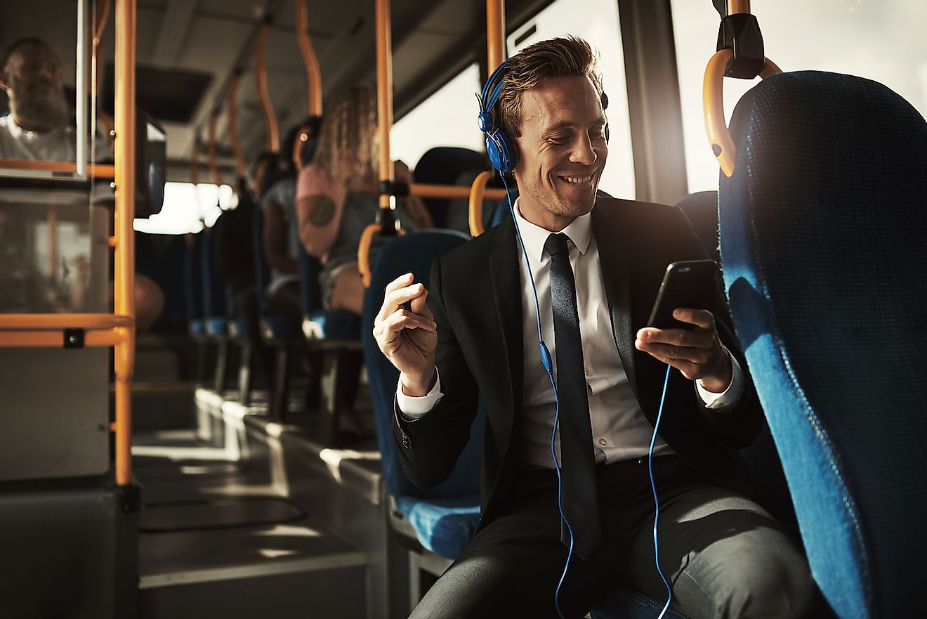 Businessman sitting on a bus during his morning commute. Image credit: Flamingo Images/Shutterstock.com