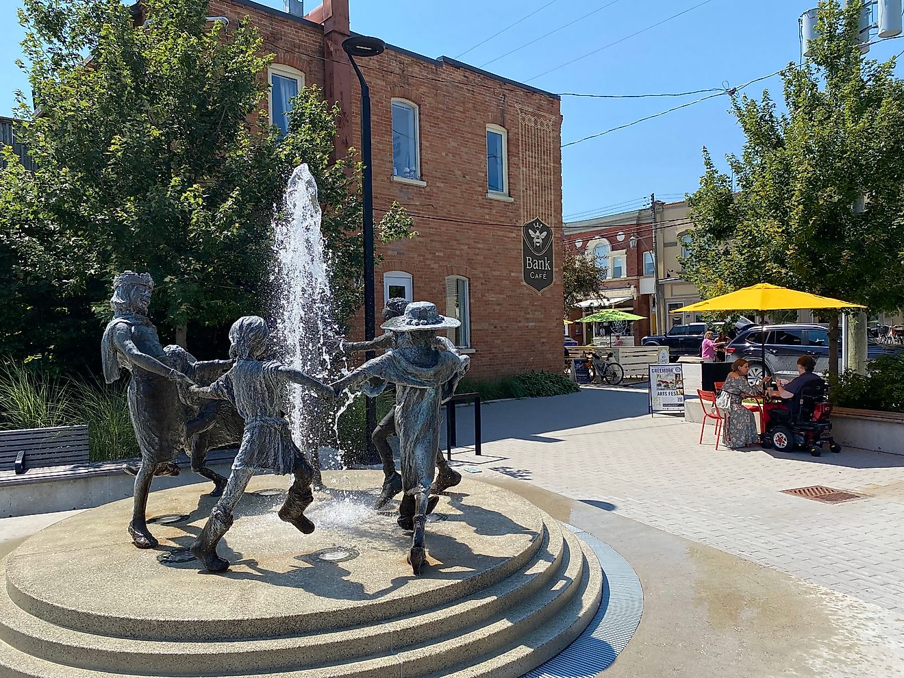 The sculpture fountain of Creemore’s Village Green courtyard flows into the sidewalk patio of the Bank Café. Photo Credit: Andrew Douglas