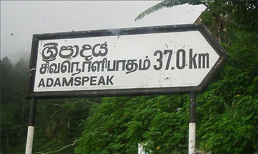 Place name sign in Sri Lanka in three languages with each linguistic version different from each other.